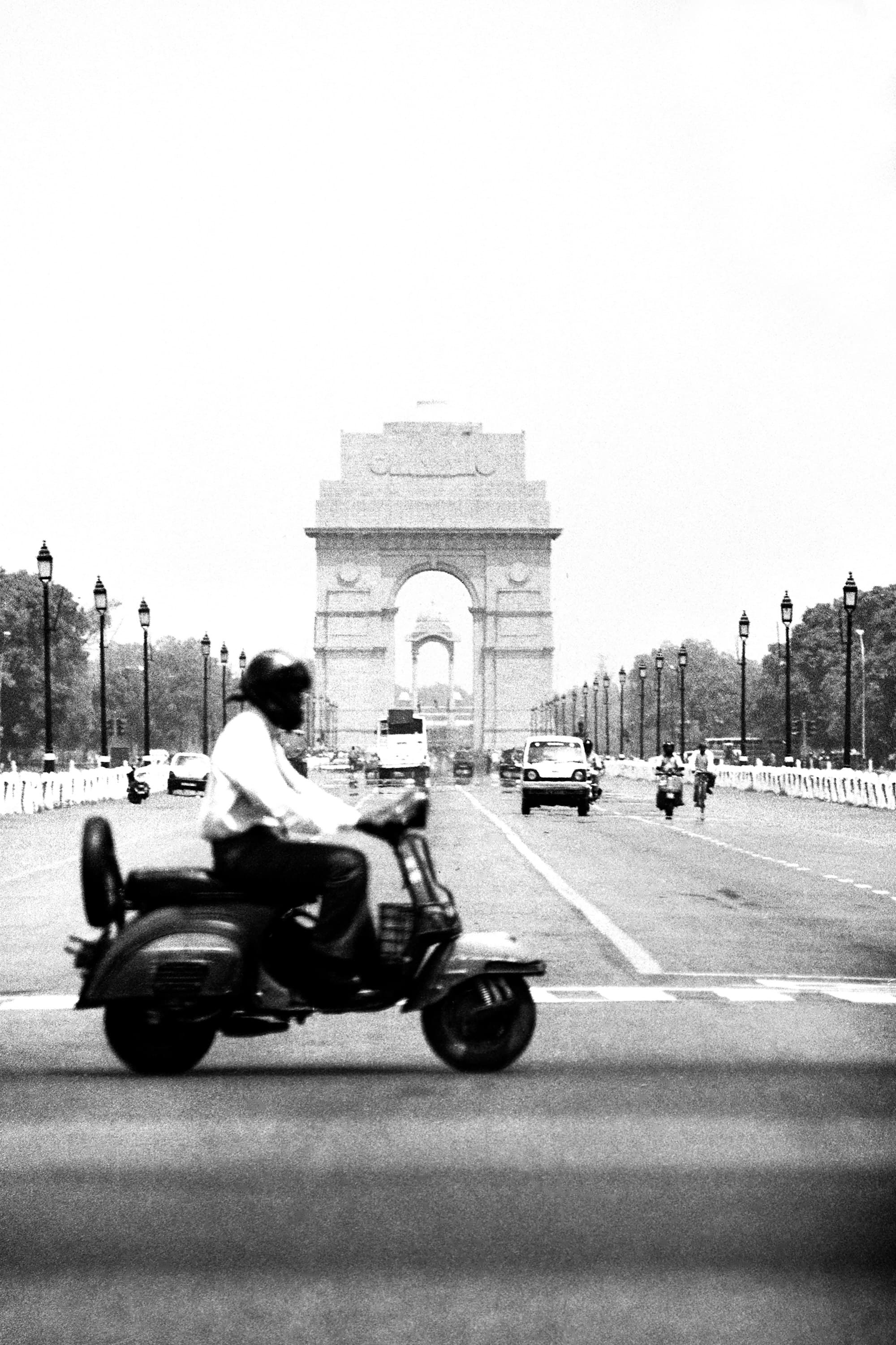 Rider on a scooter heading towards India Gate
