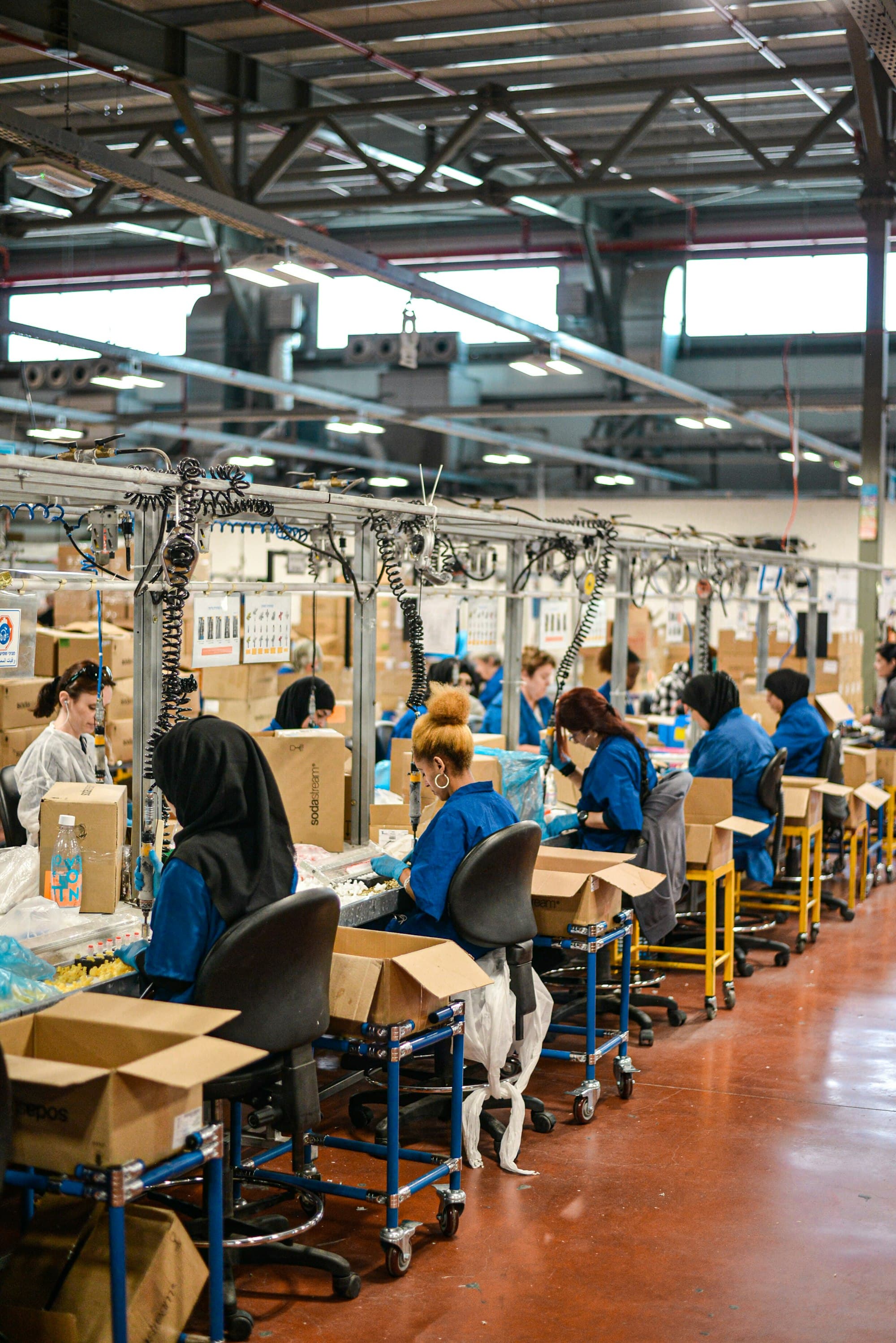Workers along a factory assembly line