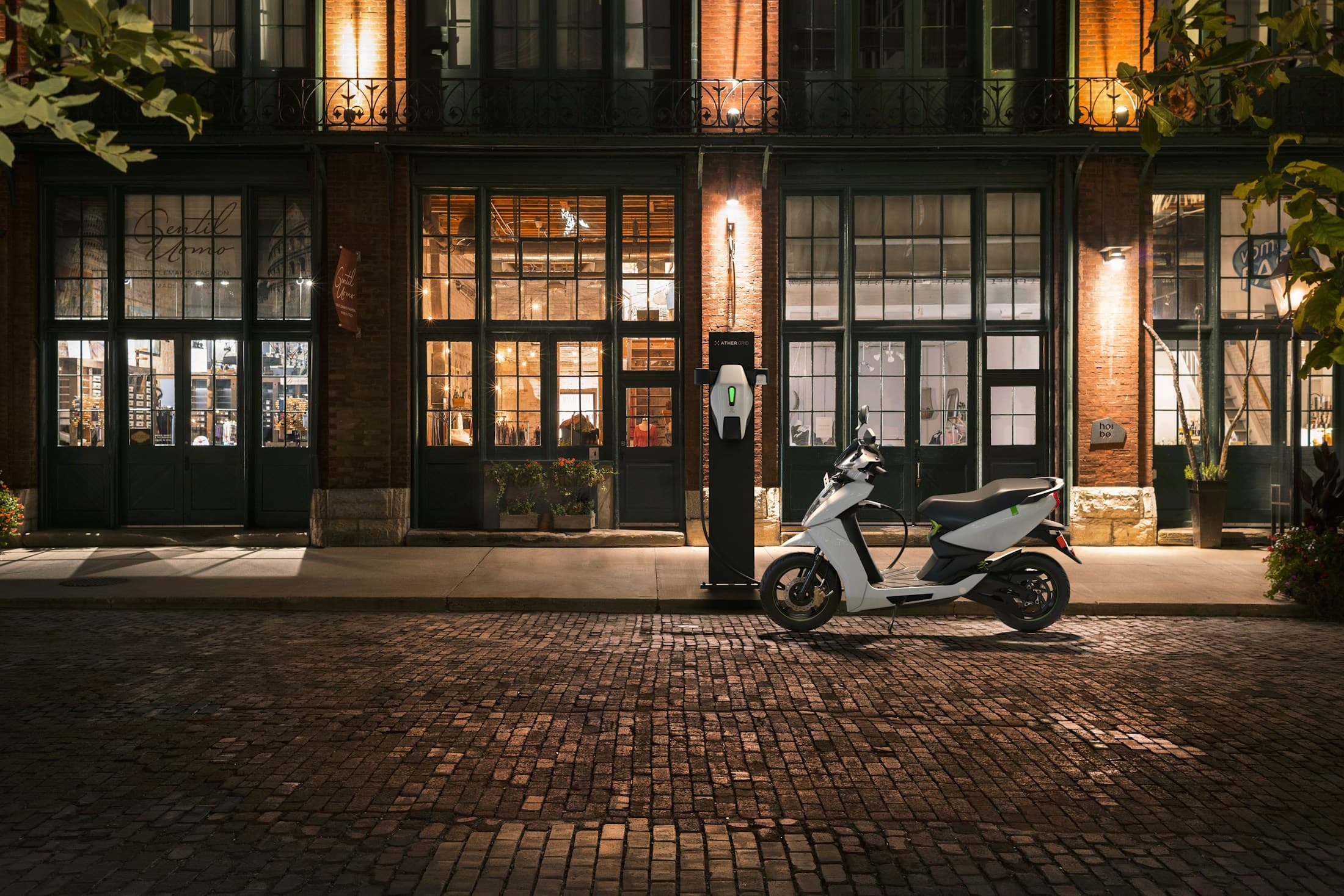 A ZAP electric scooter parked outside a lit storefront