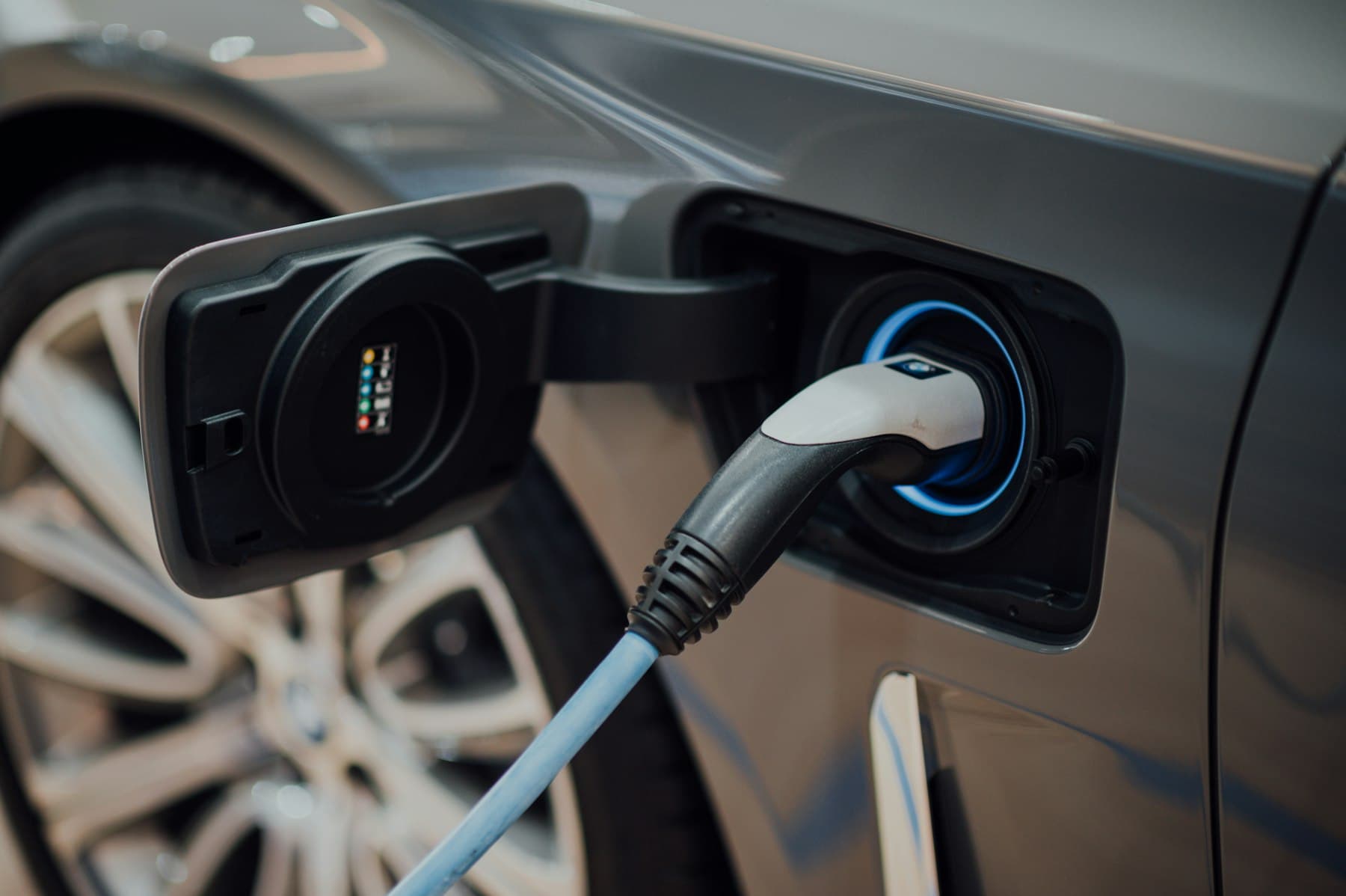 A charging cable plugged into an electric vehicle