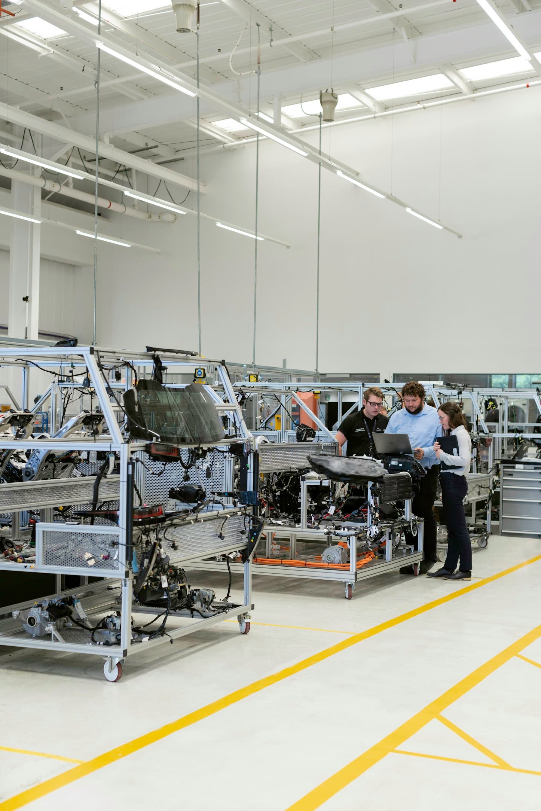 Engineers working on a vehicle assembly floor